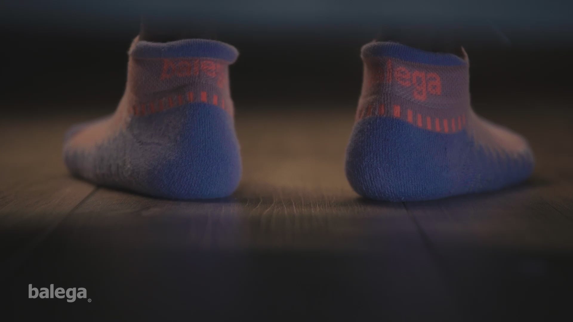 Runners wearing Balega running socks with a breakdown of anti-blister, moisture wicking design.